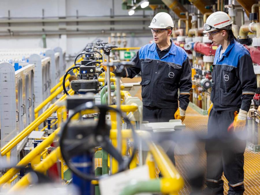 Employees working inside a factory hall.